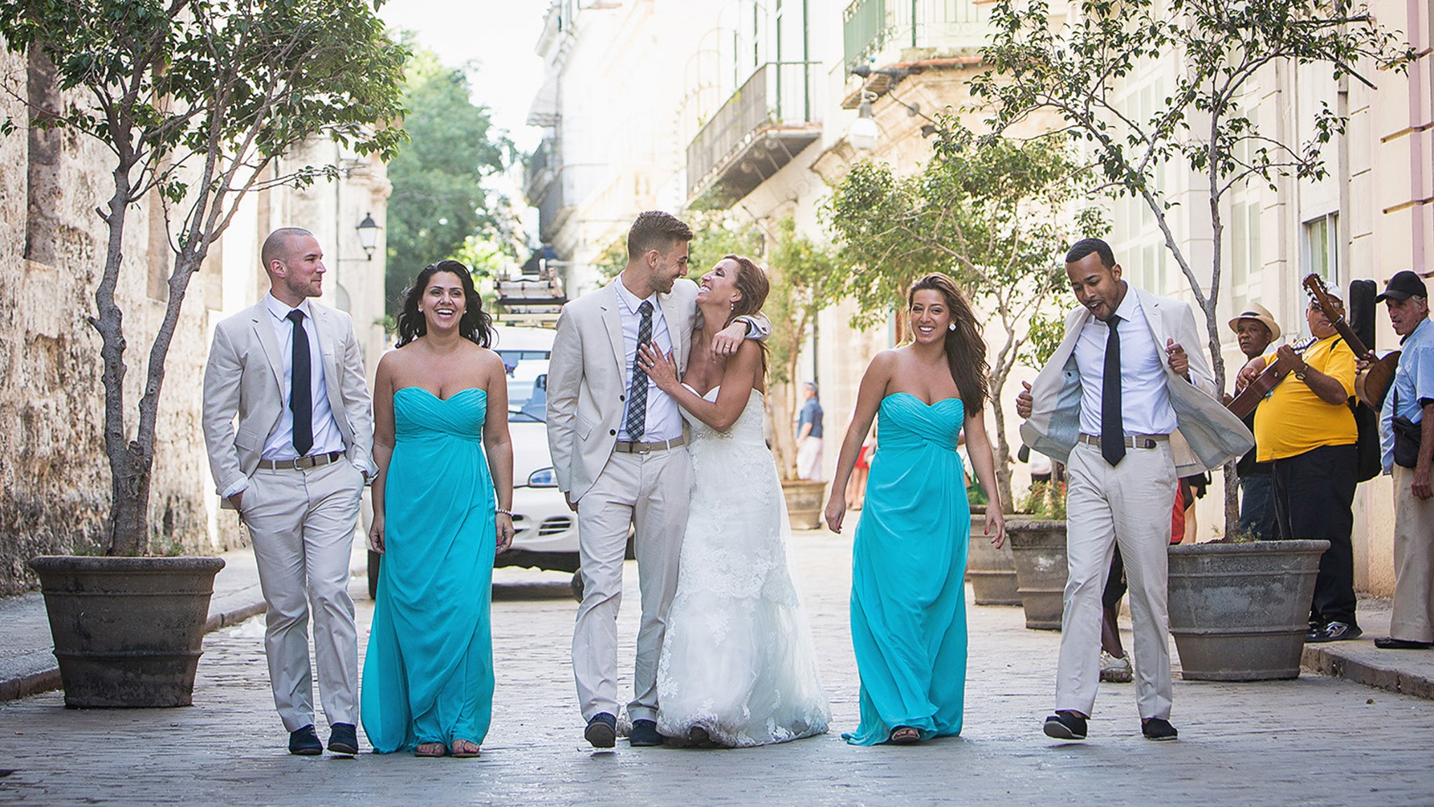 Wedding party walking through a historic street during a destination wedding in Cuba