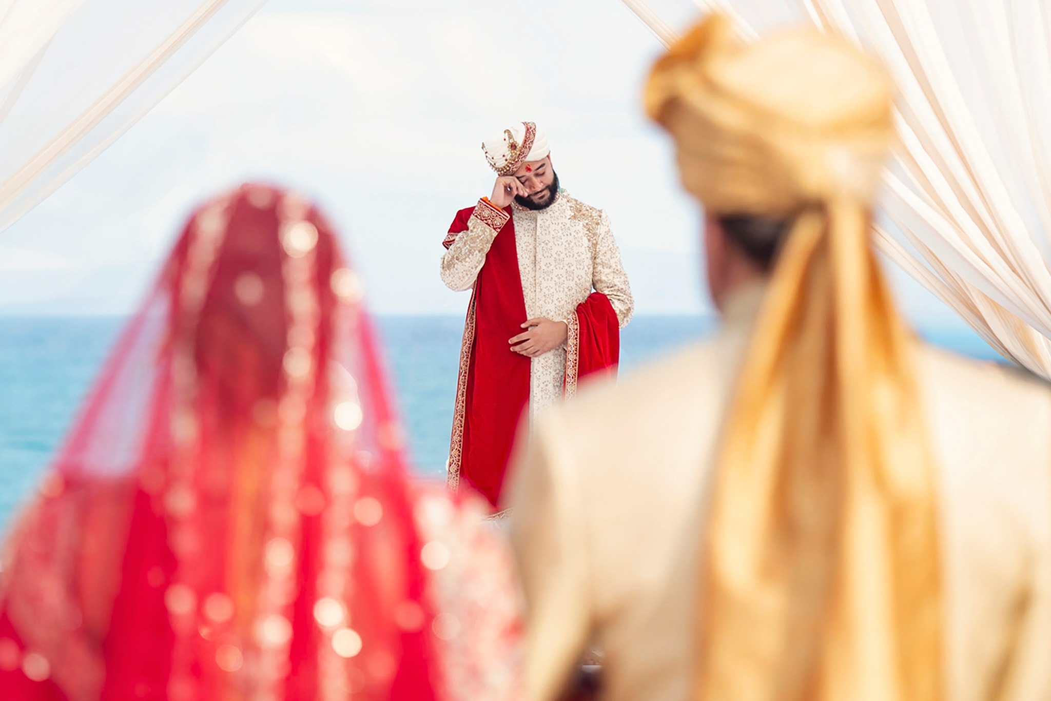 Couple seeing each other during a traditional wedding ceremony reveal