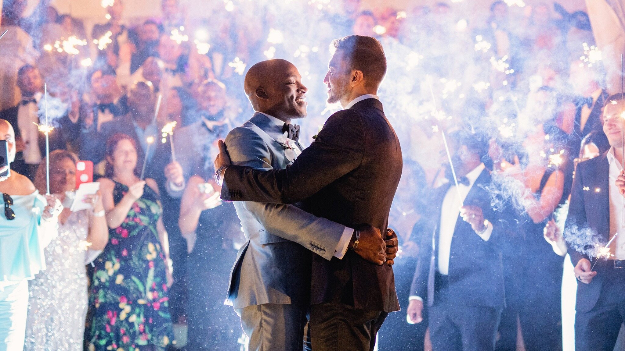 Newlywed couple walking through a sparkler exit at night during a Toronto wedding