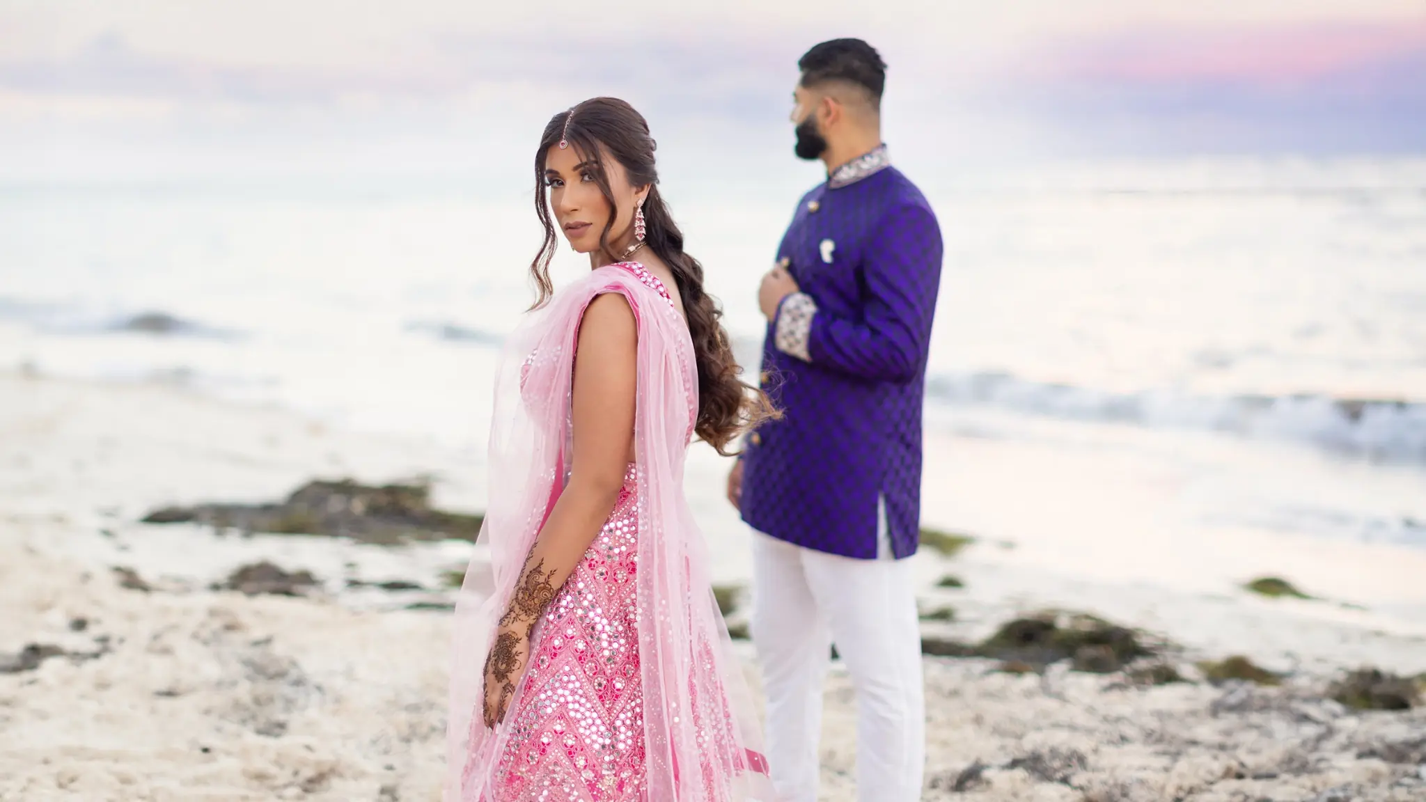 Sarika and Amal photographed by the ocean during their destination wedding in Mexico