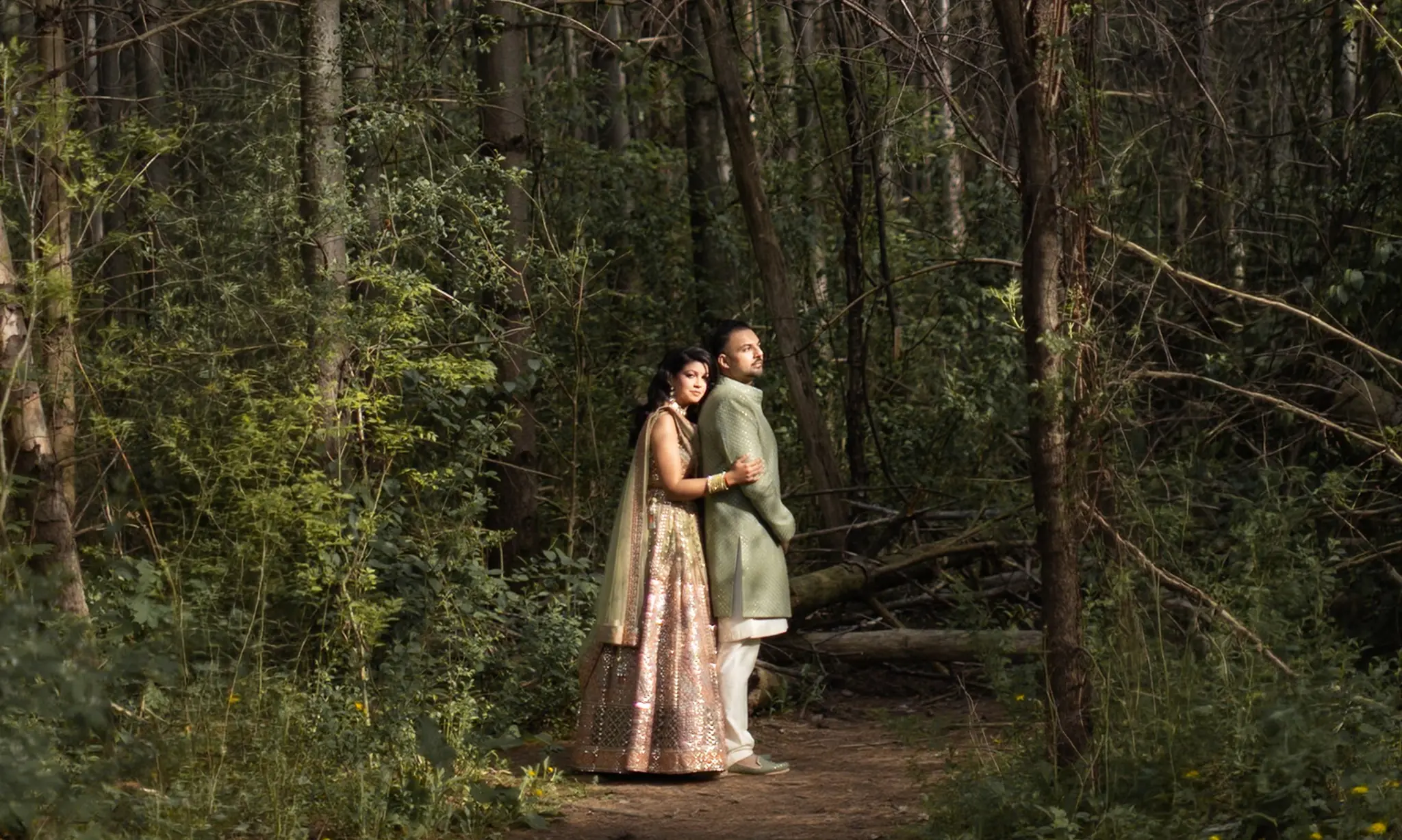 Surbhi and Nick photographed in a sunlit forest during their Hindu wedding celebration
